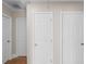 Hallway with three closed doors and hardwood floors at 408 16Th Ave. S, Myrtle Beach, SC 29577