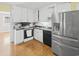 Kitchen boasts stainless steel appliances and white cabinets at 408 16Th Ave. S, Myrtle Beach, SC 29577