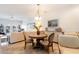 Bright dining area with a round wooden table and four chairs at 4759 Lightkeepers Way # 14A, Little River, SC 29566