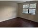 Bright bedroom with dark wood flooring and a window at 5001 Little River Rd. # E-110, Myrtle Beach, SC 29577