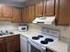 Galley kitchen with wood cabinets and modern appliances at 5001 Little River Rd. # E-110, Myrtle Beach, SC 29577