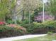 Mature trees and flowering shrubs create a picturesque landscape at 5001 Little River Rd. # E-110, Myrtle Beach, SC 29577