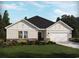 New single-story home with a two-car garage and landscaping at 5006 Riverton Ct, Myrtle Beach, SC 29579