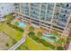 Aerial view featuring beachfront resorts, landscaping, pools and lush greenery, offering a tropical vacation experience at 501 S Ocean Blvd. # 708, North Myrtle Beach, SC 29582