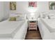 Bright bedroom featuring two beds, a nightstand, and decorative wall art at 501 S Ocean Blvd. # 708, North Myrtle Beach, SC 29582