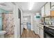 Cozy kitchenette with white cabinetry, appliances, and a view into the bedroom and bathroom at 501 S Ocean Blvd. # 708, North Myrtle Beach, SC 29582