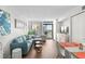 Bright living room boasts modern furniture, hardwood floors, and sliding glass doors to a private balcony at 501 S Ocean Blvd. # 708, North Myrtle Beach, SC 29582