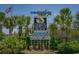 The City of North Myrtle Beach sign amidst lush greenery and palm trees, welcomes you to a tropical community at 501 S Ocean Blvd. # 708, North Myrtle Beach, SC 29582