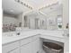 Double vanity bathroom with updated fixtures and a large mirror at 5060 Windsor Green Way # 203, Myrtle Beach, SC 29579