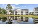 Building exterior with pond reflection at 5060 Windsor Green Way # 203, Myrtle Beach, SC 29579