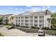 Three-story building with ample parking and a landscaped courtyard at 5060 Windsor Green Way # 203, Myrtle Beach, SC 29579