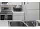 Stainless steel sink and stove top in kitchen at 5060 Windsor Green Way # 203, Myrtle Beach, SC 29579