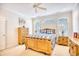 Bedroom with light wood furniture, large windows, and ceiling fan at 508 5Th Ave. S, North Myrtle Beach, SC 29582