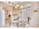 Elegant dining area with glass table, ornate chairs, and a chandelier at 508 5Th Ave. S, North Myrtle Beach, SC 29582