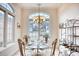 Bright dining area with glass table, ornate chairs, and large window at 508 5Th Ave. S, North Myrtle Beach, SC 29582
