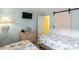 Guest bedroom with twin beds, light blue walls, and sliding barn door at 600 S Ocean Blvd. # C-21, North Myrtle Beach, SC 29582
