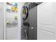 Laundry closet with LG stacked washer and dryer, and storage shelves at 600 S Ocean Blvd. # C-21, North Myrtle Beach, SC 29582