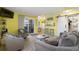 Bright living room with gray sofas and yellow walls, open to kitchen at 600 S Ocean Blvd. # C-21, North Myrtle Beach, SC 29582