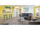 Living room with gray couch and yellow walls, near kitchen and bedroom at 600 S Ocean Blvd. # C-21, North Myrtle Beach, SC 29582