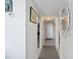 White hallway with tile floors and artwork, connecting rooms at 601 Mitchell Dr. # 1002, Myrtle Beach, SC 29577