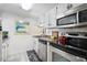 Bright kitchen features stainless steel appliances and white cabinets at 601 Mitchell Dr. # 1002, Myrtle Beach, SC 29577