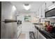 Bright kitchen features stainless steel appliances and white cabinets at 601 Mitchell Dr. # 1002, Myrtle Beach, SC 29577