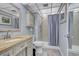 Small bathroom with shower/tub combo and light vanity at 7601 North Ocean Blvd. # 1B, Myrtle Beach, SC 29572