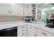 White kitchen with black appliances and breakfast bar at 7601 North Ocean Blvd. # 1B, Myrtle Beach, SC 29572