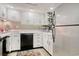 White kitchen with black appliances and ample counter space at 7601 North Ocean Blvd. # 1B, Myrtle Beach, SC 29572