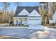 Beautiful light blue house with a two-car garage and rocking chairs on the porch at 848 Commanders Island Rd., Georgetown, SC 29440