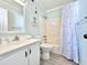 Bathroom with shower/tub combo, white vanity, and patterned shower curtain at 1000 N Waccamaw Dr. # 302, Murrells Inlet, SC 29576