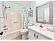 Bathroom with shower/tub combo, white vanity, and coastal decor at 1000 N Waccamaw Dr. # 302, Murrells Inlet, SC 29576