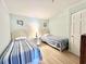 Bedroom with twin beds, striped bedding, and wood nightstand at 1000 N Waccamaw Dr. # 302, Murrells Inlet, SC 29576