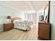 Bedroom with coastal bedding, wood nightstand, and large window at 1000 N Waccamaw Dr. # 302, Murrells Inlet, SC 29576