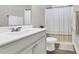 Neat bathroom featuring a single sink, toilet, shower with curtain, and tile floors at 104 Grace Bay Ct., Pawleys Island, SC 29585