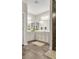Bright bathroom with double sinks, large mirrors, and tile flooring at 104 Grace Bay Ct., Pawleys Island, SC 29585