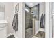 Modern bathroom with a glass-enclosed shower featuring gray tiles and a rainfall showerhead at 104 Grace Bay Ct., Pawleys Island, SC 29585