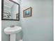 Charming half bathroom with a pedestal sink and decorative mirror at 104 Grace Bay Ct., Pawleys Island, SC 29585