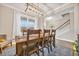 Dining area with a wooden table and chairs, and view of stairs at 104 Grace Bay Ct., Pawleys Island, SC 29585