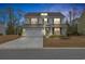 Charming home with a two-car garage, well-manicured lawn, and a welcoming entrance at 104 Grace Bay Ct., Pawleys Island, SC 29585