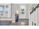 Bright foyer featuring a staircase, hardwood floors, and a decorative table at 104 Grace Bay Ct., Pawleys Island, SC 29585
