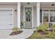 Close-up of front door with decorative wreath, sidelights, and craftsman details at 104 Grace Bay Ct., Pawleys Island, SC 29585
