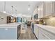 Modern kitchen with stainless appliances and white cabinets that opens to the living area at 104 Grace Bay Ct., Pawleys Island, SC 29585