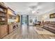 Inviting living room with wood floors, a ceiling fan, and a sliding glass door to the patio at 104 Grace Bay Ct., Pawleys Island, SC 29585
