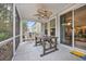 Relaxing screened-in patio with a ceiling fan and outdoor seating area at 104 Grace Bay Ct., Pawleys Island, SC 29585