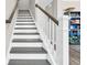 Elegant staircase with white risers, a dark gray treads, and a modern white railing at 104 Grace Bay Ct., Pawleys Island, SC 29585