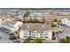 An aerial view of the condo building in a developing community near a pond at 1100 Possum Trot Rd. # E-238, North Myrtle Beach, SC 29582