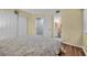 Comfortable bedroom with hardwood floors, closet, and view to the bathroom at 1100 Possum Trot Rd. # E-238, North Myrtle Beach, SC 29582