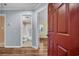 The condo entrance opens to reveal wood flooring and a view of the bathroom and bedroom at 1100 Possum Trot Rd. # E-238, North Myrtle Beach, SC 29582