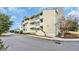 Multi-level condo building featuring private balconies and traditional architecture with light yellow siding at 1100 Possum Trot Rd. # E-238, North Myrtle Beach, SC 29582